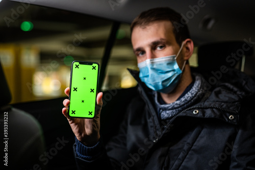 Obraz na płótnie Young passenger showing something on his phone during coronavirus pandemic w salonie