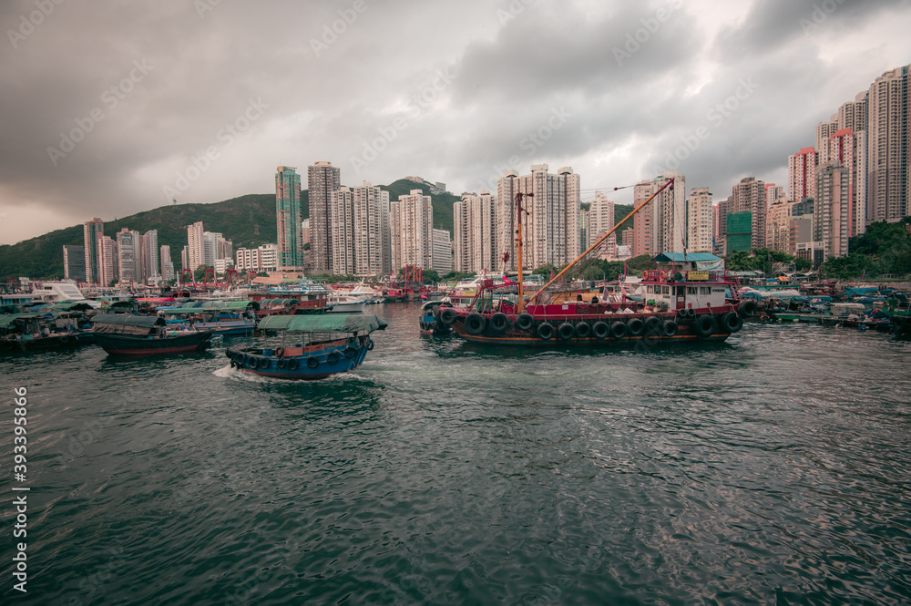 Fototapeta premium Aberdeen Harbour seen from Ap Lei Chau Bridge, In this area you will find fishing boats, houseboats, and sampans, The bay between the south coast of Hong Kong Island