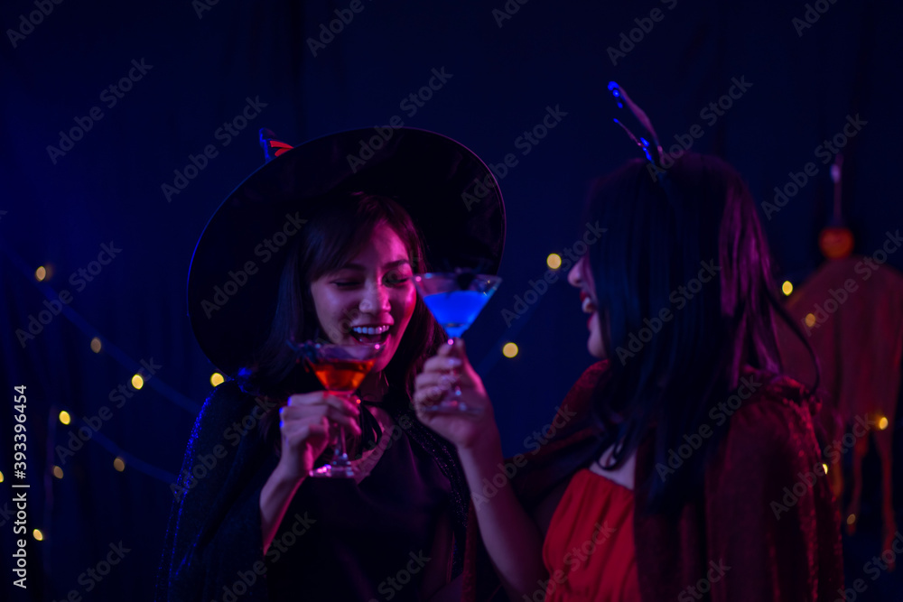attractive Asian women enjoy party night life with wine drinking glasses in hand. Halloween festival celebration concept. attractive Asian women enjoy party night life with wine drinking glasses in hand. Halloween festival celebration concept.