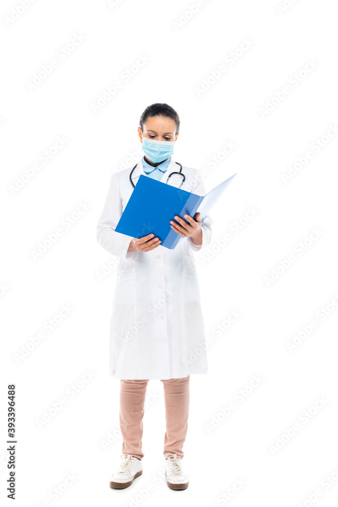 African american doctor in medical mask holding paper folder isolated on white African american doctor in medical mask holding paper folder isolated on white