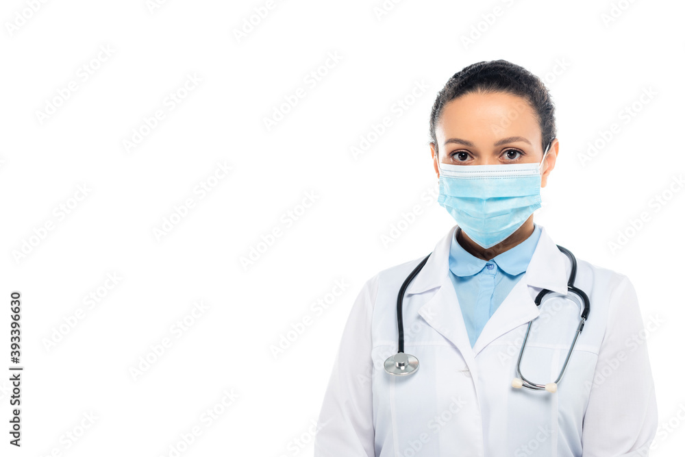 African american doctor in medical mask and stethoscope looking at camera isolated on white African american doctor in medical mask and stethoscope looking at camera isolated on white