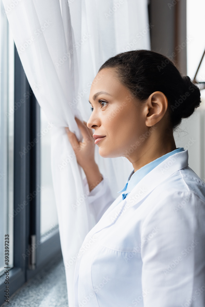 African american doctor looking at window in clinic African american doctor looking at window in clinic