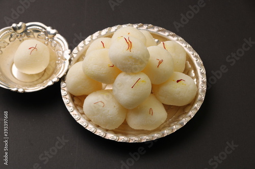 Famous Indian dessest rasgulla/ rosogulla/ roshogulla served in silver plate / bowl photo