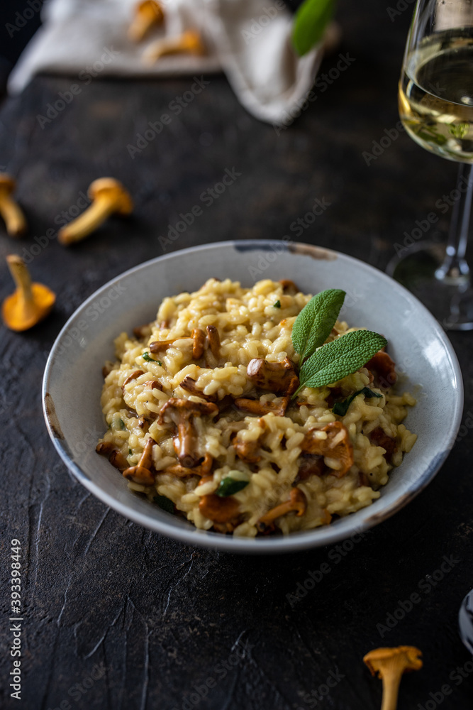 Risotto with chanterelles and saga leaves. Risotto and white wine