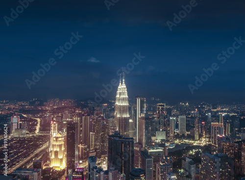 Petronas Towers, colorful vibrant twilight after sunset. Panoramic night scene of Kuala Lumpur, Malaysia, Asia. Image is ideal for background. Toned image.
