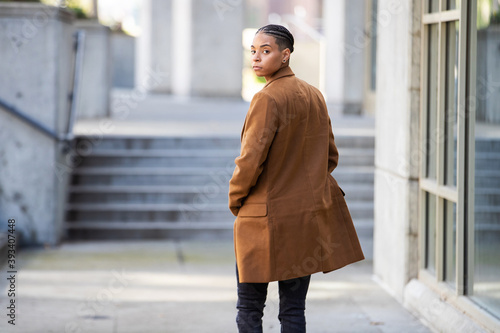Obraz na plátne Young African American walking away and looking over her shoulder