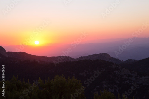 Dawn bathes the Catalina Mountains of Arizona with layers of red and yellow