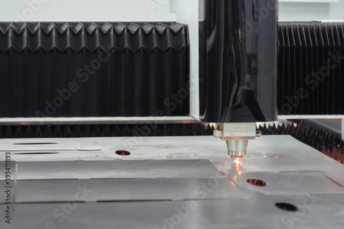Automatic cnc laser cutting machine working with sheet metal at factory, plant. Metalworking, machining, industrial, equipment, technology, manufacturing concept