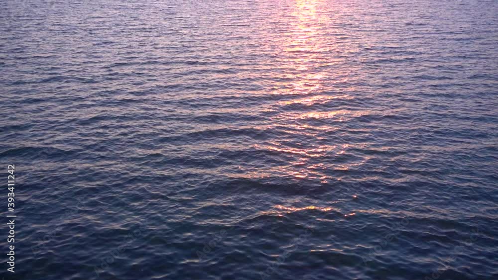 Slow motion beautiful calm water surface and sun reflection. Looped video. Slow motion beautiful calm water surface and sun reflection. Looped video.
