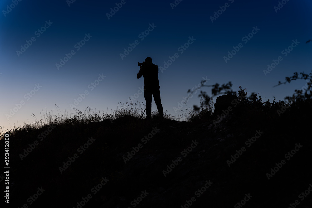  silhouette of person taking pictures