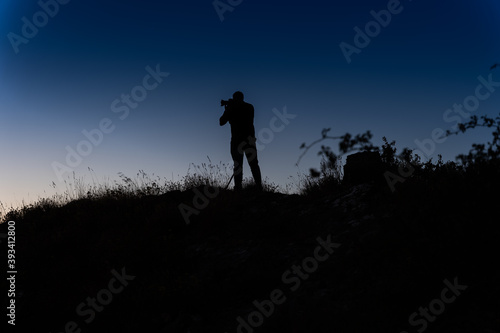  silhouette of person taking pictures