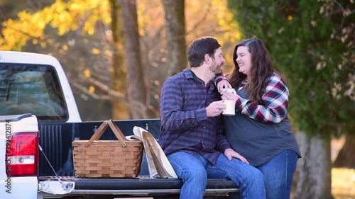 Couple, with pick-up making plans for traveling with map coffee and picnic basket