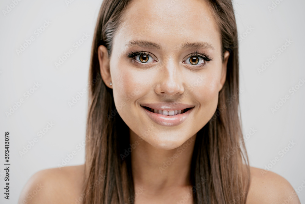 portrait of young beauty woman clean healthy skin natural natural makeup. Spa concept brunette hair smooth Shine, smiling white teeth. looking at the camera portrait of young beauty woman clean healthy skin natural natural makeup. Spa concept brunette hair smooth Shine, smiling white teeth. looking at the camera