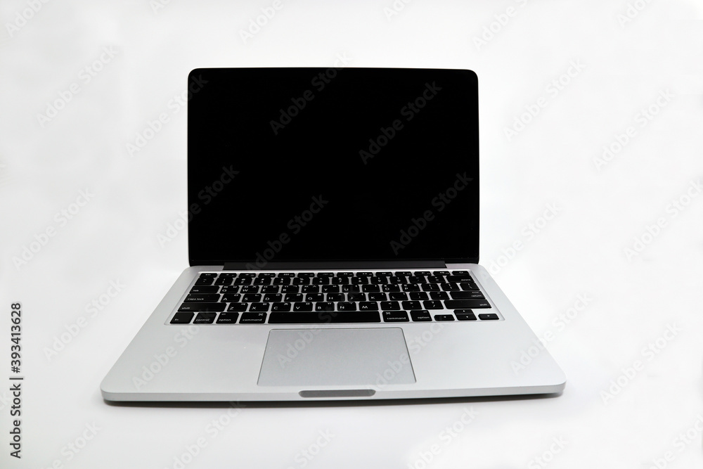 a silver laptop computer that has been used for a long time for work. a silver laptop computer that has been used for a long time for work.