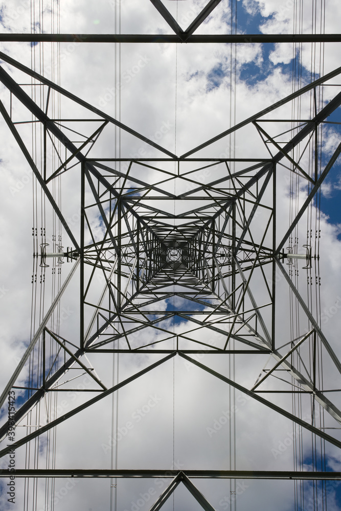 Fototapeta premium Power lines run vertically through this abstract image of a pylon.