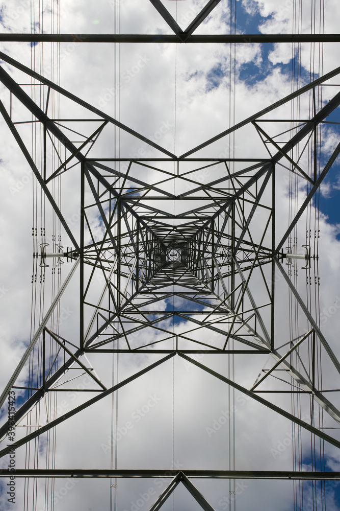 Power lines run vertically through this abstract image of a pylon.