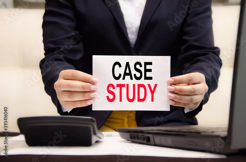 case study text written on a blank sheet of paper held by a business girl