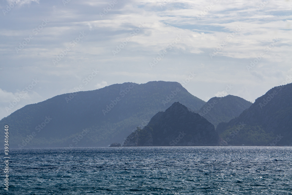 Summer mediterranean coastal landscape. View of Cirali Beach from ancient Olympos ruins, with mountains in background Antalya Turkey. Summer mediterranean coastal landscape. View of Cirali Beach from ancient Olympos ruins, with mountains in background Antalya Turkey.