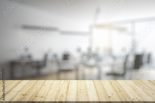 Blank wooden table top with light furnished office on background, mockup © Pixels Hunter
