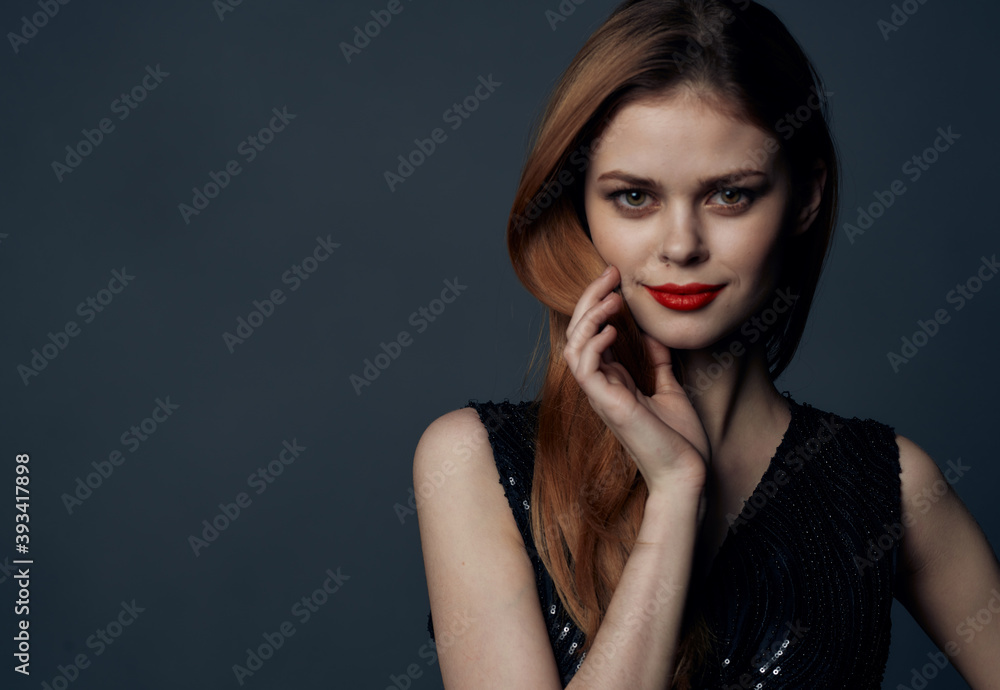 Charming lady in a black dress with red hair evening makeup gray background Copy Space Charming lady in a black dress with red hair evening makeup gray background Copy Space