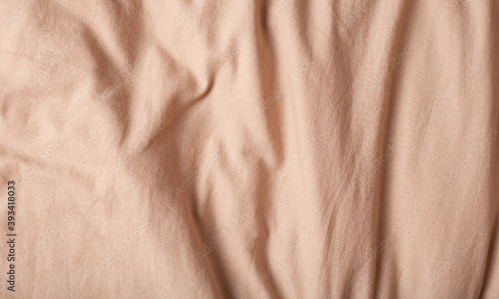 Soft beige fabric texture waves abstract background.
Soft beige fabric texture waves abstract background.