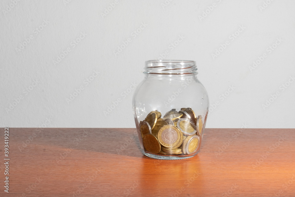 Argentine Coins in money jar on isolated background Argentine Coins in money jar on isolated background
