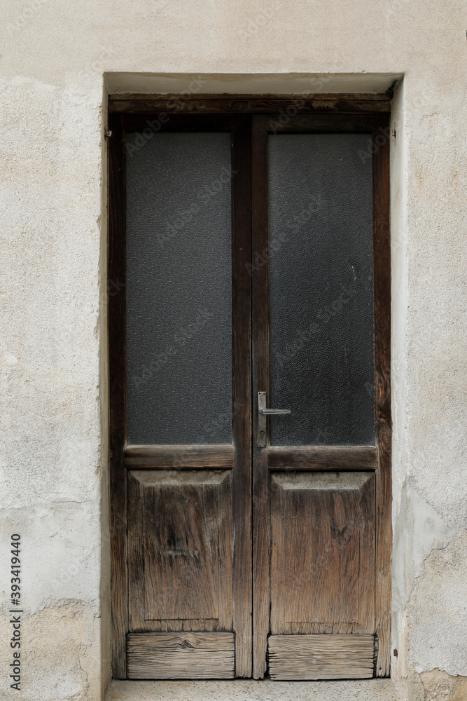old weathered wooden door with glass in building, entrance door closed, no person, picture perfect for background or gift card