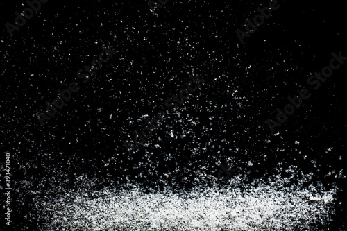 Snowflakes particles isolated on black background. Abstract template for design