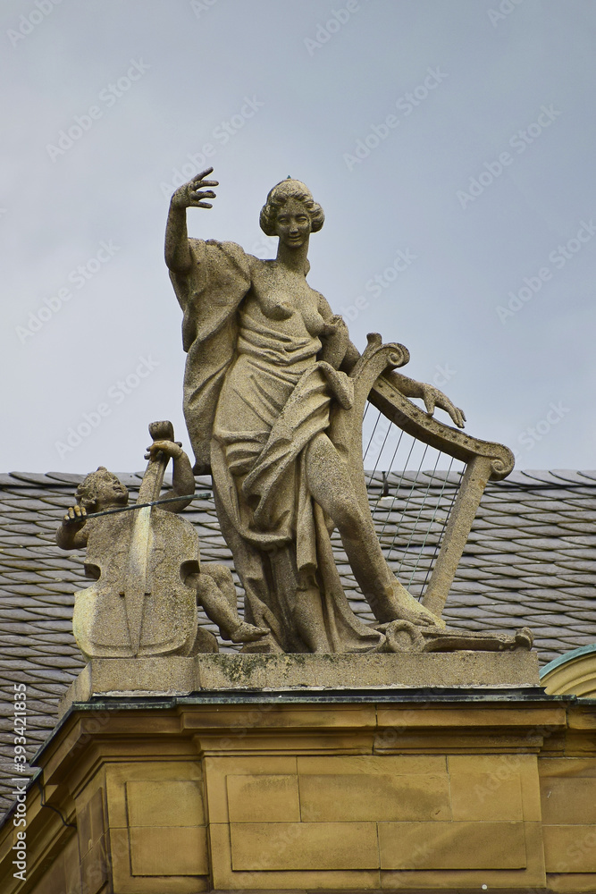 Sculpture of a woman with a harp and a child with a violin