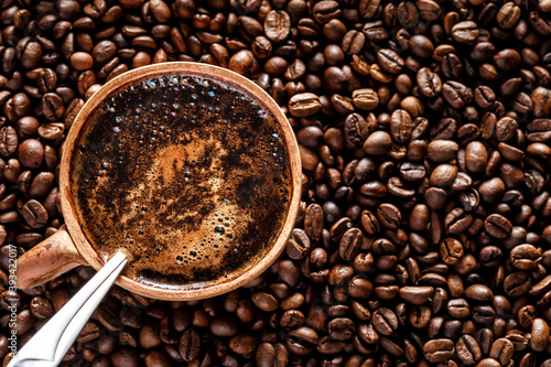 Coffee with milk cup and roasted beans.Coffee beans wallpaper. Coffee background. Side view.