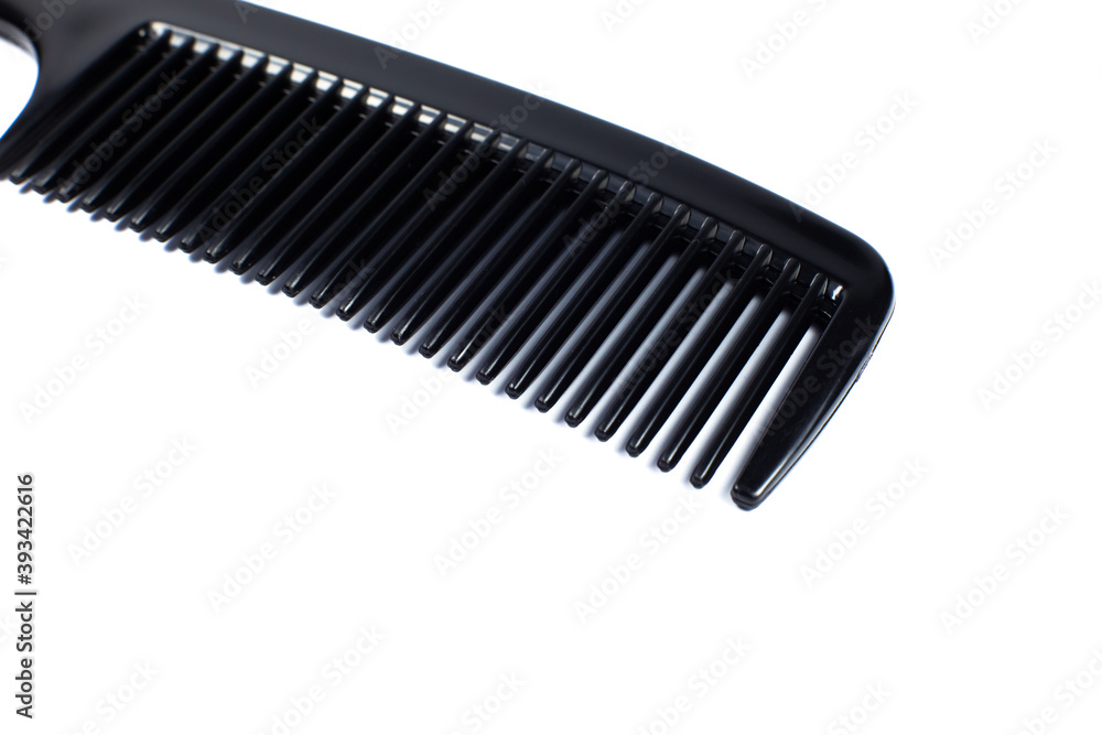 Black comb on white background. Close up. Black comb on white background. Close up.