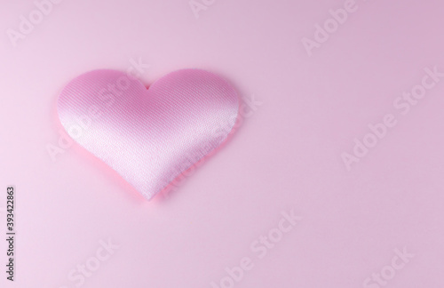 Pink heart on pink background. Saint Valentine s day concept. Love and romantic photo. Postcard for holiday. Beautiful warm wallpaper with love. Soft focus. Copy space.