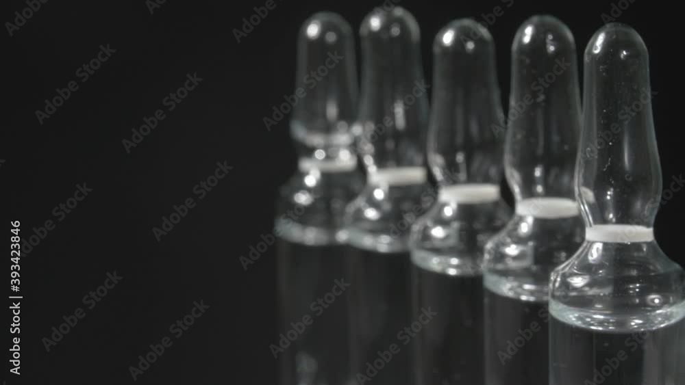 Close-up ampoules. Black background. A drug to treat diseases. Close-up ampoules. Black background. A drug to treat diseases.
