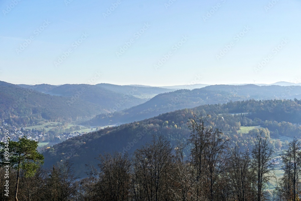 panoramic view over valley, hills and forest with sunshine