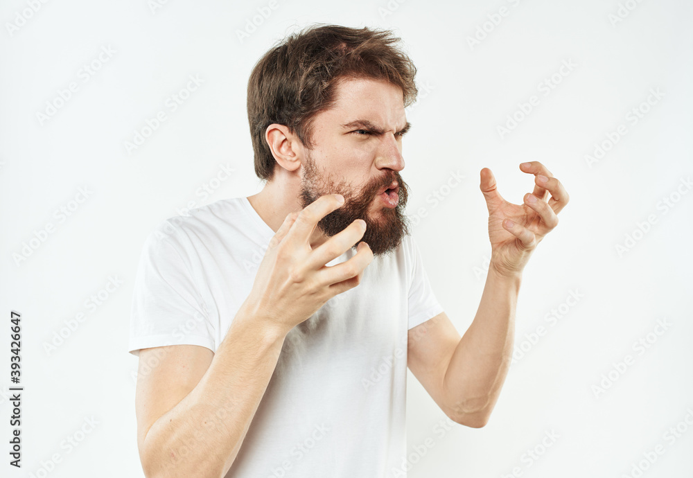 A man with a thick beard gestures irritably with his hands stress emotions A man with a thick beard gestures irritably with his hands stress emotions