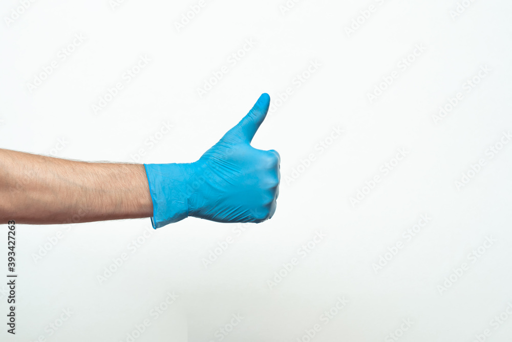 Doctor hand with glove showing like gesture or thumbup as approval, accept or done concept. Copy space. place for text Doctor hand with glove showing like gesture or thumbup as approval, accept or done concept. Copy space. place for text