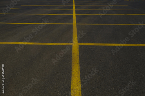 yellow lines in the big black asphalt international way, asphalt parking area, car park  © On The Backof Camera