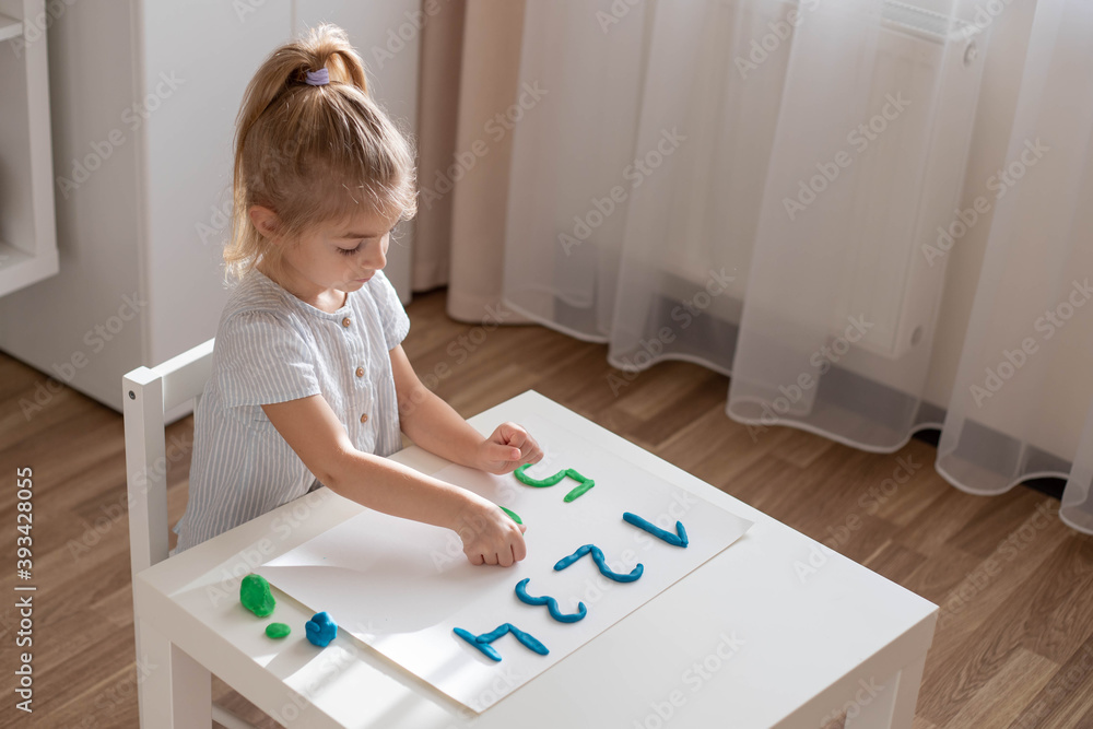Little girl make a numbers from plasticine. Home education, DIY, home made activities for preschooler. Little girl make a numbers from plasticine. Home education, DIY, home made activities for preschooler.