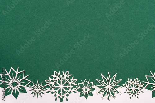 Green Christmas background with white snowflake border