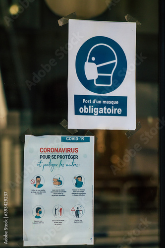 View of an information poster to protect yourself from the Coronavirus in the streets of Reims on business windows in order to limit its progression in the population photo