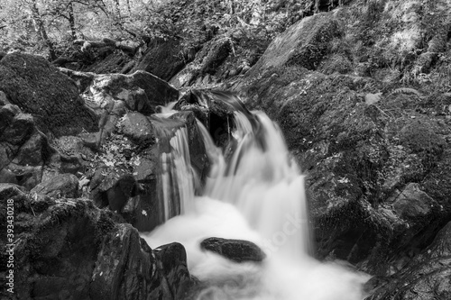 Long exposure of a waterfall on the Hoar Oak Water river flowing through the woods at Watersmeet in Exmoor National Park photo