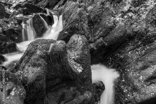 Long exposure of a waterfall on the Hoar Oak Water river flowing through the woods at Watersmeet in Exmoor National Park photo