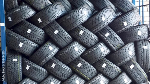 Stack of car tires on warehouse in tire store, close up, 4K