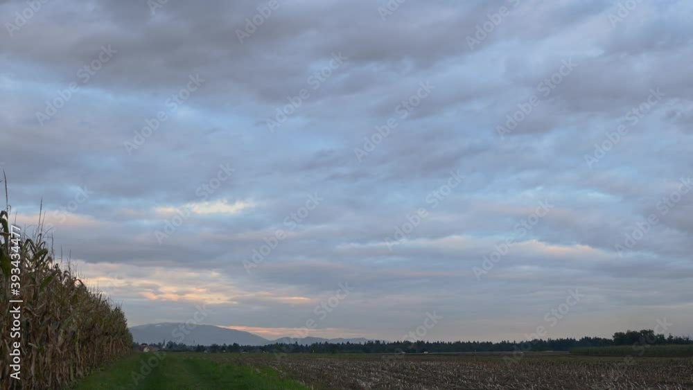 Time lapse clouds moving over empty farming field. Autumn season. Static shot, wide angle Time lapse clouds moving over empty farming field. Autumn season. Static shot, wide angle