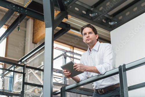 Wallpaper Mural Businessman with tablet in factory thinking Torontodigital.ca