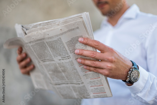 Close-up of businessman reading newspaper