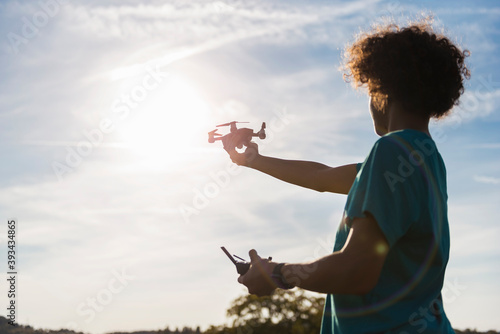 Boy flying a drone outdoors photo