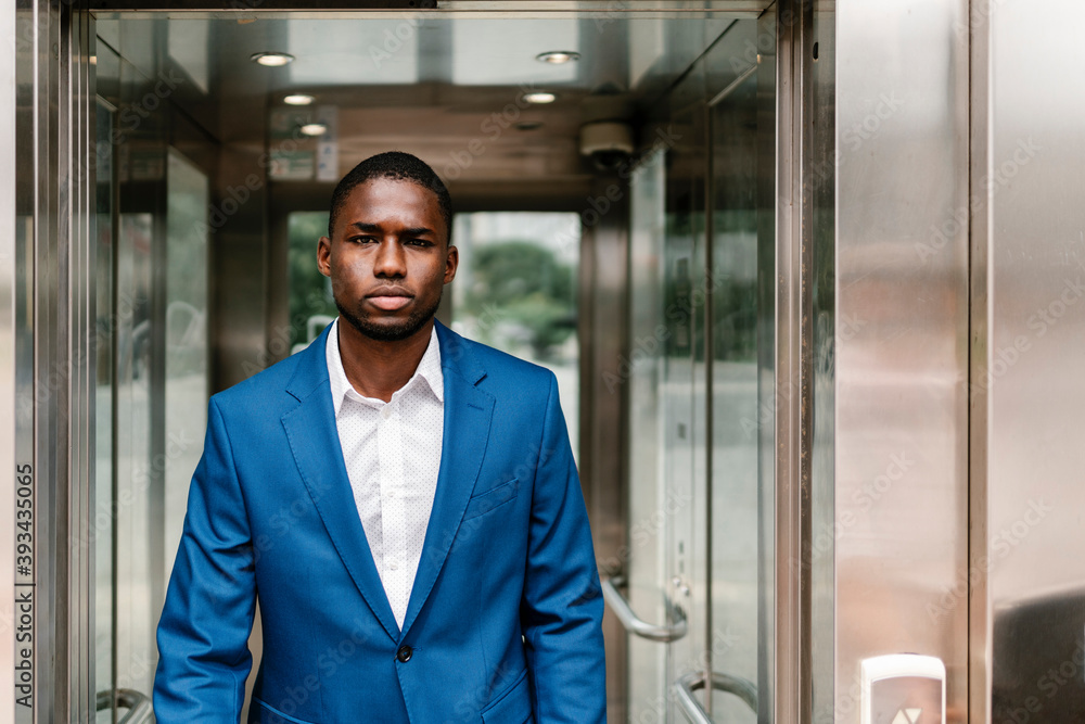 Confident young male professional walking in corridor Confident young male professional walking in corridor