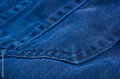 clothing items stonewashed cotton fabric texture with seams, clasps, buttons and rivets, macro