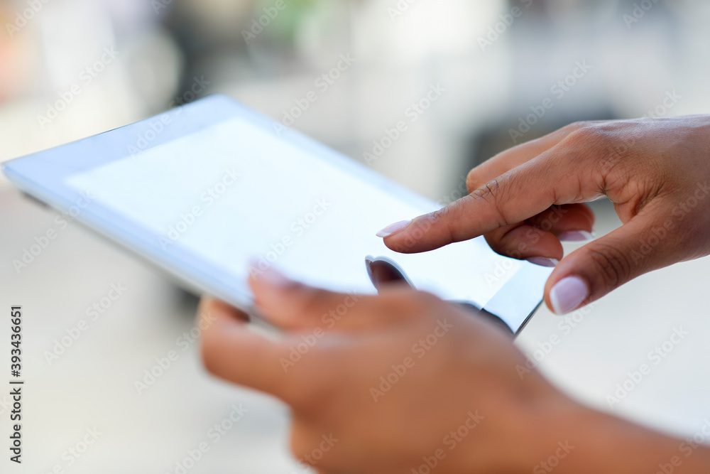 Close-up of woman's hands using tablet outdoors Close-up of woman's hands using tablet outdoors